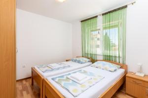 a small bedroom with a bed and a window at Dragan K1 in Medulin