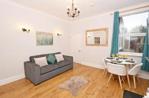a living room with a couch and a table at Tranquil Oasis in the Heart of the Stoke-on-Trent! in Stoke on Trent