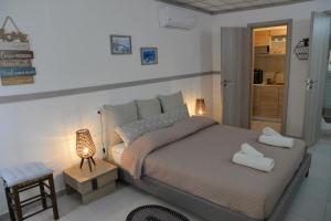 Posteľ alebo postele v izbe v ubytovaní Ifigenia Apartments