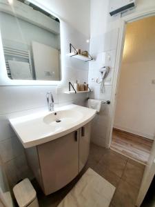 a bathroom with a sink and a mirror at La Caponnière in Carcassonne +45 photos