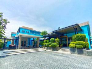 a blue house with a courtyard in front of it at Beach Walk Boutique Resort in Bangsaen
