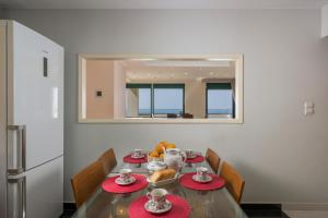 a dining room with a table with red plates and a mirror at Vaggelio House in Chania Town