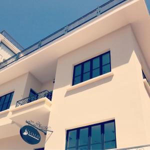 a white building with a sign on it at Solo Boutique Hotel in Antalya