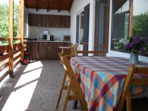 a porch with a table and chairs and a kitchen at Villa Exotica in Balchik +49 photos