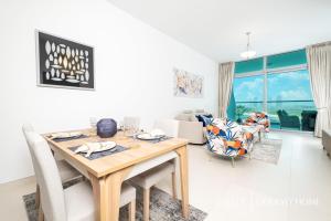 comedor y sala de estar con mesa y sillas en LUX Opulent Island Suite 6 Burj View en Dubái