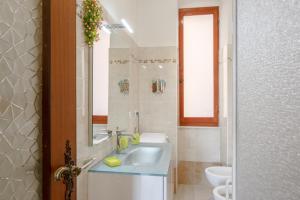a bathroom with a sink and a toilet at GuestHost - Cadimare Lovely Apartment in La Spezia +7 photos
