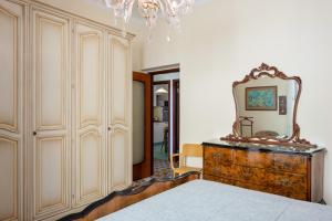 a bedroom with a dresser with a mirror on it at GuestHost - Cadimare Lovely Apartment in La Spezia