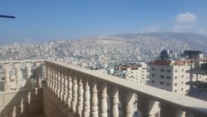 a view of a city from the balcony of a building at Nablus luxury Residence in Nablus