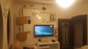 a living room with a flat screen tv on a wall at Nablus luxury Residence in Nablus