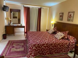 Postel nebo postele na pokoji v ubytování Gran Hotel Ciudad Del Sur