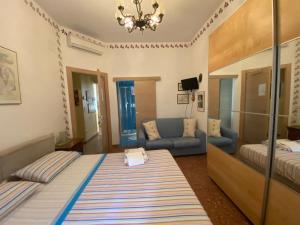 a living room with a bed and a couch at Casa Riri in San Benedetto del Tronto