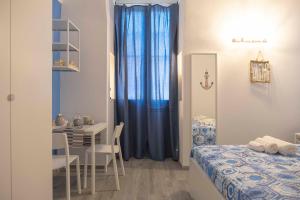 a room with a bed and a table and a dining room at Il Pendio B&B in Bisceglie