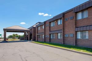 an empty parking lot in front of a brick building at Quality Inn in Saint Cloud