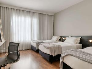 Cama ou camas em um quarto em Mercure Belo Horizonte Lourdes