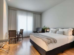 Cama ou camas em um quarto em Mercure Belo Horizonte Lourdes