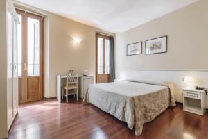 Postel nebo postele na pokoji v ubytování Hotel Astoria
