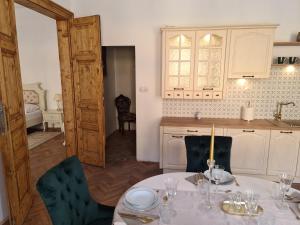 a kitchen with a table with plates on it at Apartmány Svätá Barborka in Banská Štiavnica +19 photos