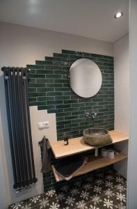 a bathroom with a sink and a mirror at B&B 't Speulderbos in Ermelo