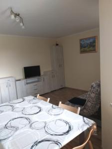 a dining room with a table with plates on it at Apartmaji Maki in Bled
