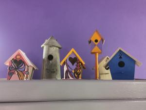 a group of birdhouses sitting on top of a shelf at Casa Pressenda Apartment in La Morra