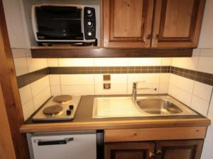 a kitchen with a sink and a microwave at Studio Les Saisies, 1 pièce, 4 personnes - FR-1-293-2 in Les Saisies