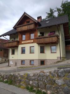 a house with a balcony on the side of it at Apartmaji Maki in Bled
