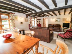 a living room with a wooden table and chairs at Meadow Lea in Liskeard