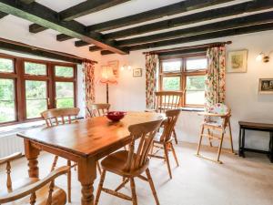 a dining room with a wooden table and chairs at Meadow Lea in Liskeard