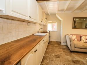 a kitchen with a sink and a counter top at Chapel Cottage in Redcar +14 photos