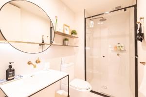 a bathroom with a shower and a sink and a toilet at Trendy 1 Bedroom Apartment in the Heart of Collingwood in Melbourne