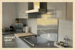 a kitchen with a sink and a microwave at Secret Spot Apartment - Quinta da Barca in Esposende