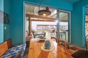 a dining room with a table and a dining room with a view of the ocean at Aptera Beach in Amoudara Herakliou