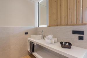 a bathroom with a sink and a mirror at Eptanisos Beachfront Suites Zante in Keri