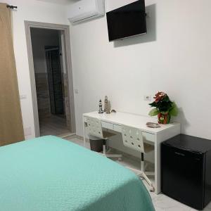 Televízia a/alebo spoločenská miestnosť v ubytovaní B&B Bentu de Mari