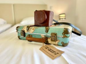 two pieces of luggage sitting on top of a bed at Villa Rosa - with private pool in Alcantarilha +32 photos