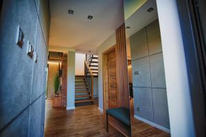 two views of a hallway with a staircase in a house at Na Skraju Raju in Zator