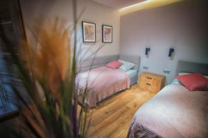 a bedroom with two beds and a vase of flowers at Na Skraju Raju in Zator