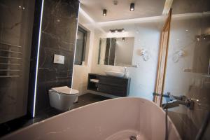 a bathroom with a tub and a toilet and a sink at Na Skraju Raju in Zator