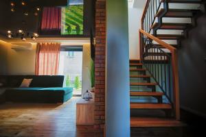 a living room with a staircase and a blue couch at Na Skraju Raju in Zator