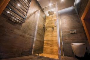 a bathroom with a shower stall and a toilet at Na Skraju Raju in Zator