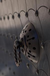 a metal object is attached to a metal fence at Allegory Boutique Hotel in Rhodes Town