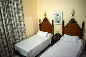 Postel nebo postele na pokoji v ubytování Hotel Playa de Regla