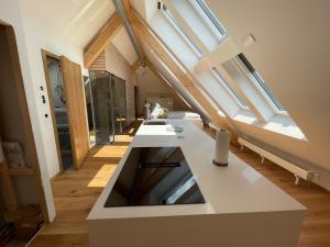 an attic kitchen with skylights and white counter top at Landhotel und Apartments Sonneck in Feldberg +91 photos