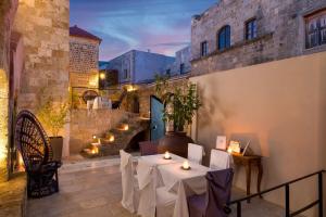 a restaurant with tables and candles in a building at Allegory Boutique Hotel in Rhodes Town