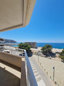 a view of the beach from the balcony of a building at Moraira Beach in Moraira