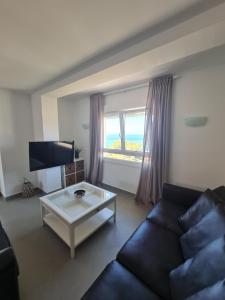 a living room with a couch and a coffee table at Moraira Beach in Moraira