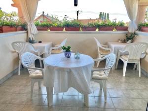a white table and chairs on a patio at Fodor Ház in Gyenesdiás