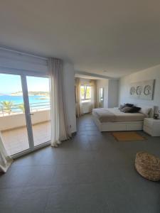 a bedroom with a bed and a view of the ocean at Moraira Beach in Moraira