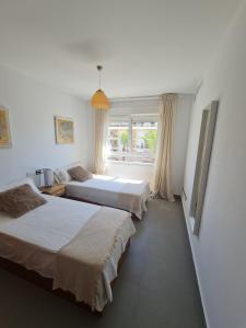 a bedroom with two beds and a window at Moraira Beach in Moraira