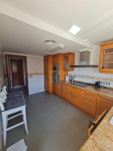 a large kitchen with wooden cabinets and a table at Moraira Beach in Moraira